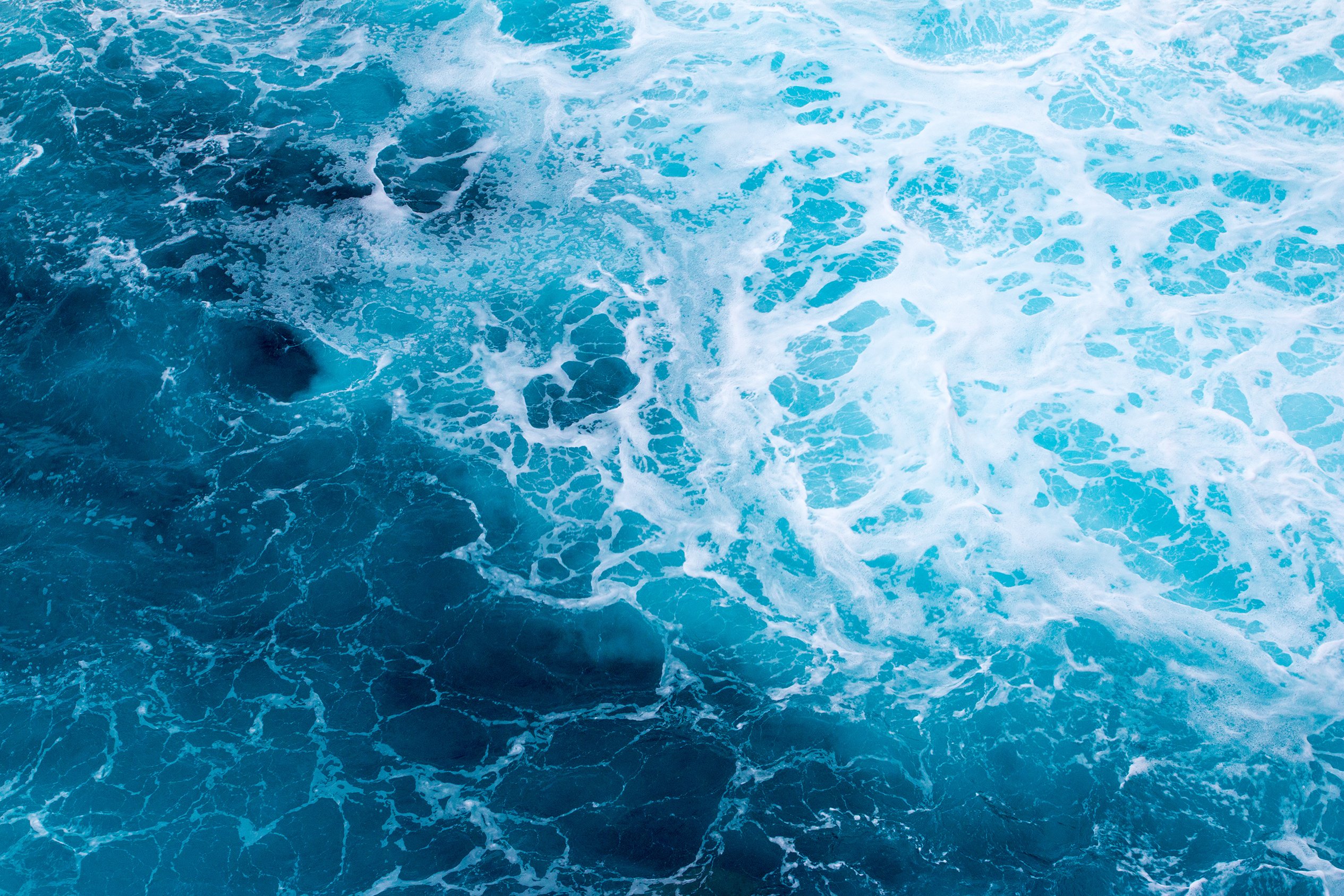 Sea surface with swirls and waves. Indian ocean near Reunion Island coastline.